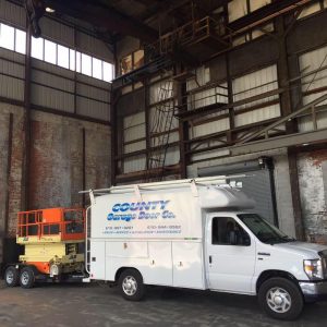 county garage door co truck in a commercial garage ready to install