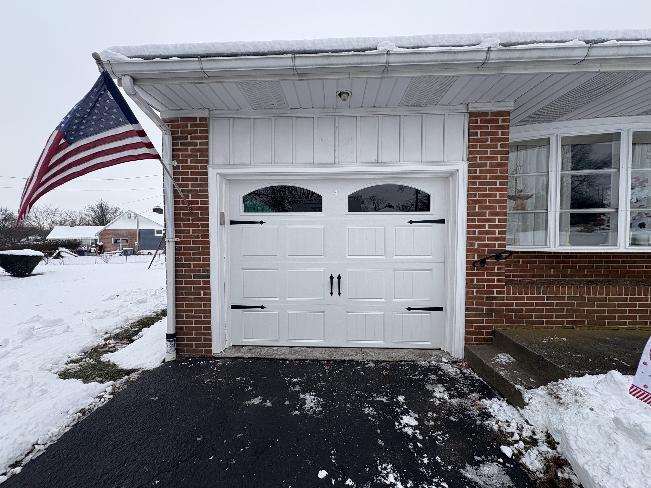 new garage door with windows and handles